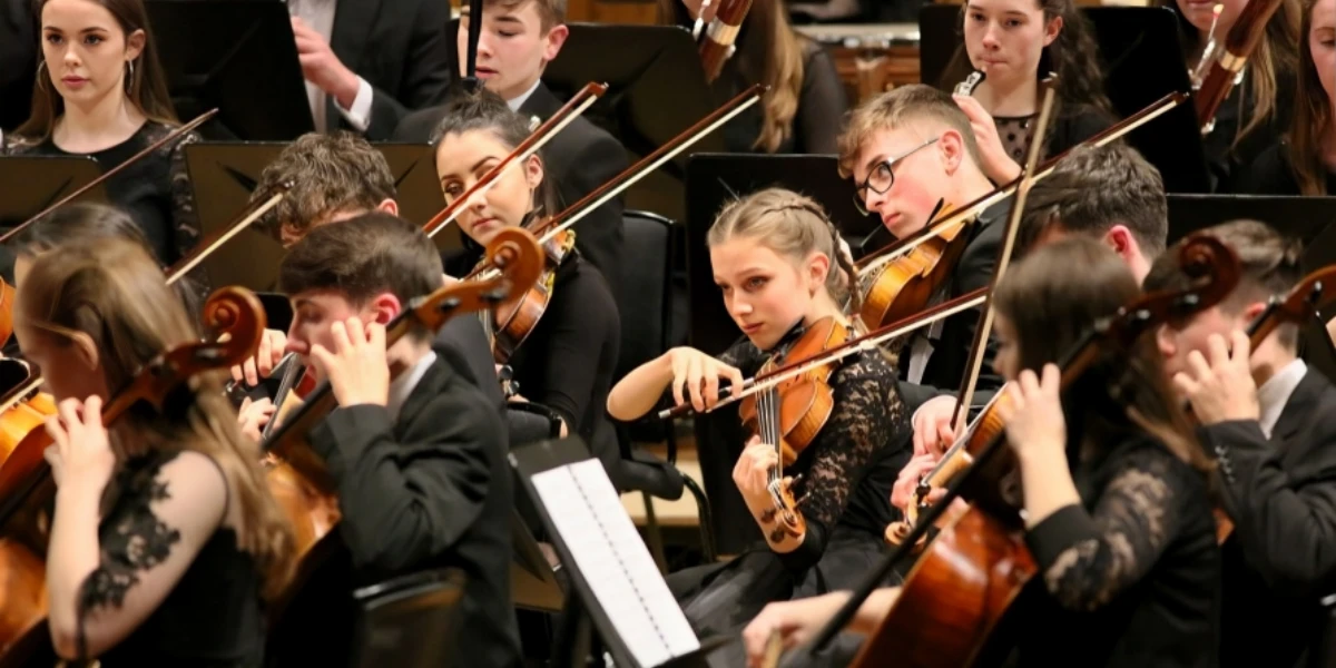 Banner showcasing group playing violin, highlighting its importance in the cathedral's music programs and performances.